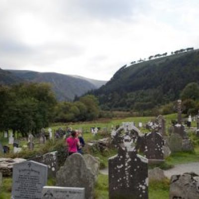 people walking though glendalough-cementery