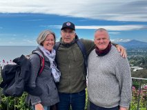 a group of people standing next to a body of water